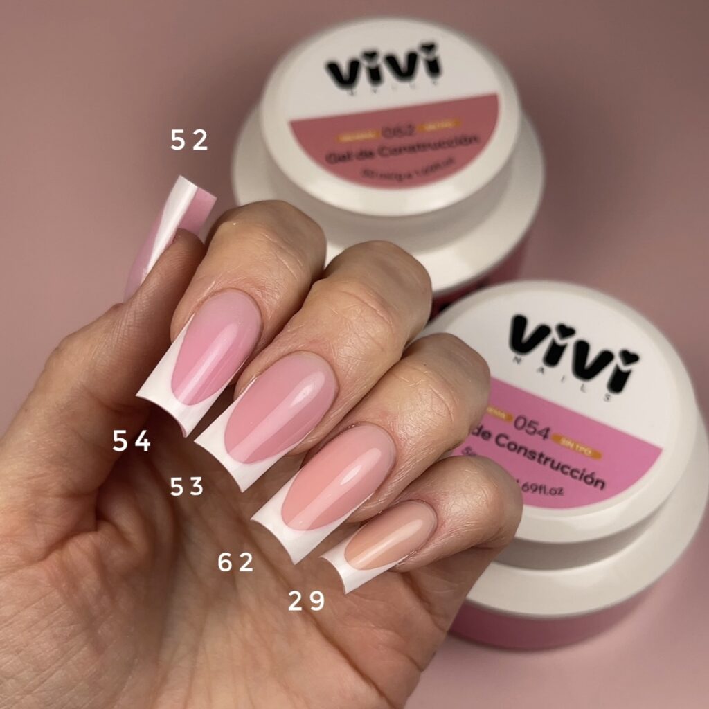 Mano con uñas largas cuadradas en rosa y punta blanca junto a tarros de gel de construcción, cada uña con el número de su tono